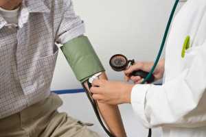 Doctor Taking Man's Blood Pressure