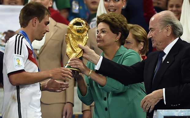 A presidente Dilma Rousseff entrega a taça da Copa do Mundo ao capitão da seleção da Alemanha, Philipp Lahm, no estádio do Maracanã (Foto: FABRICE COFFRINI/AFP)
