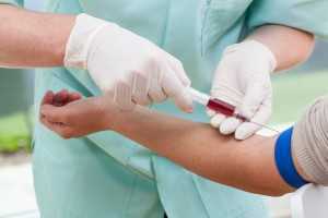 A nurse sampling patients blood to test it